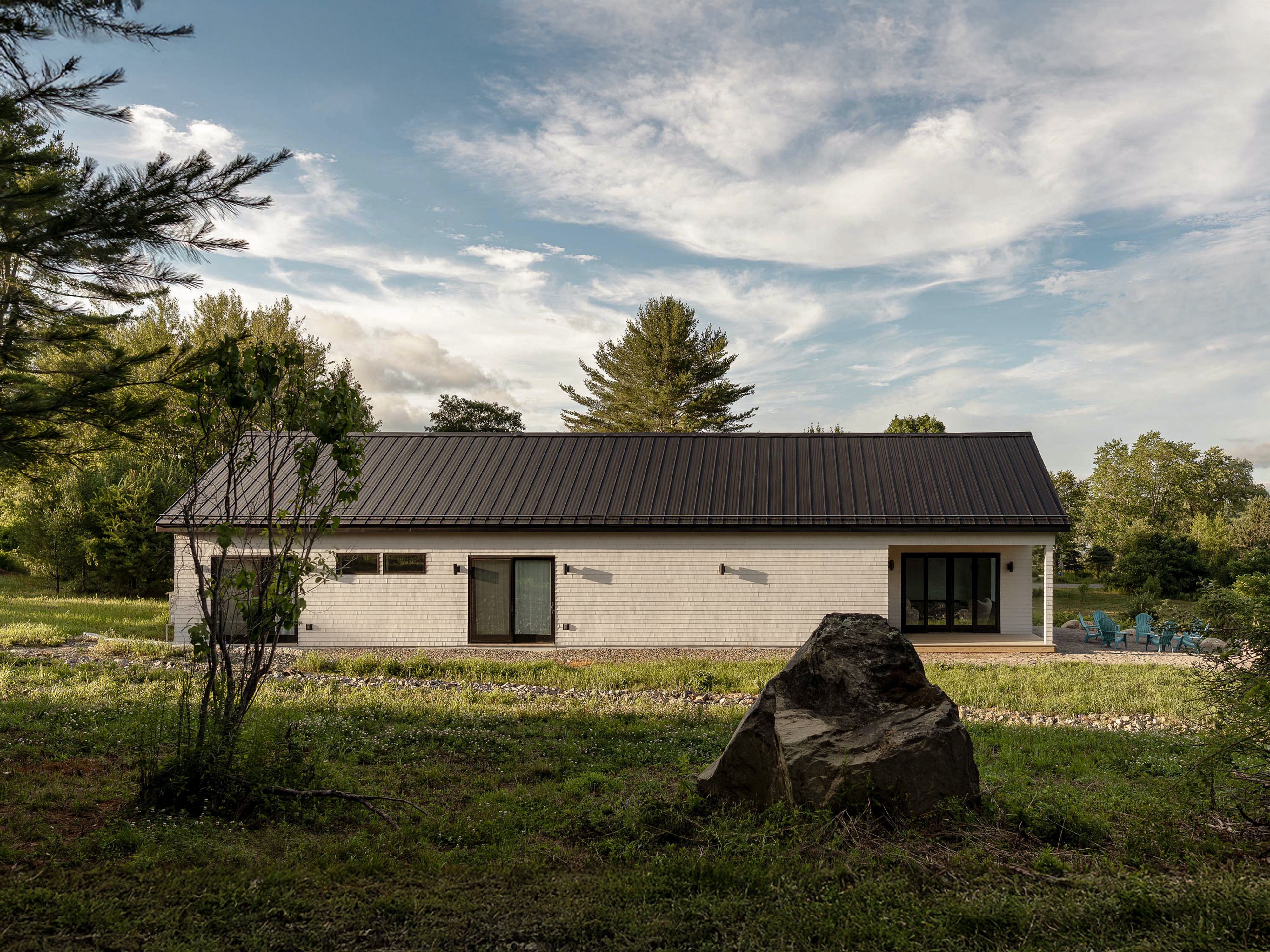 Stone estate home with evening lighting